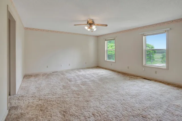 a bathroom with a bathtub and a window