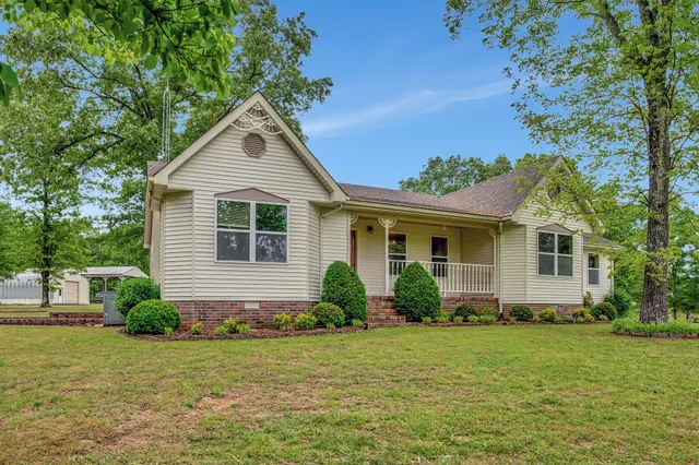 a front view of house with yard and green space