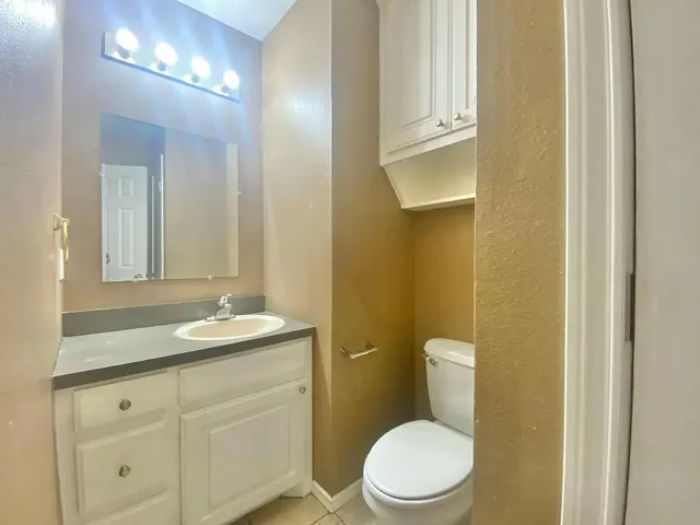 a view of an empty room and a bathroom