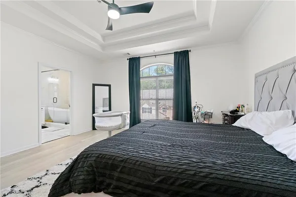 a bedroom with a large bed and a large window