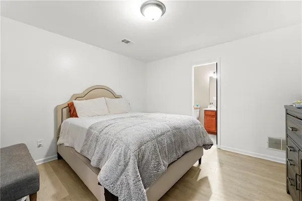 a bedroom with a bed and a dresser