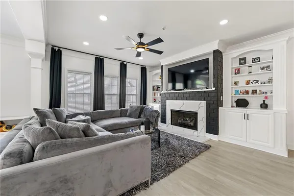 a living room with furniture fireplace and flat screen tv