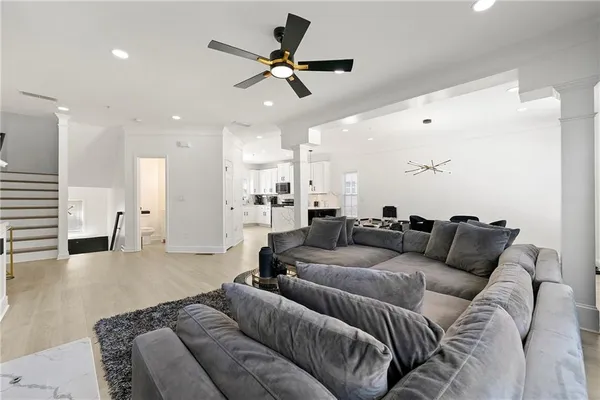 a living room with furniture and kitchen view