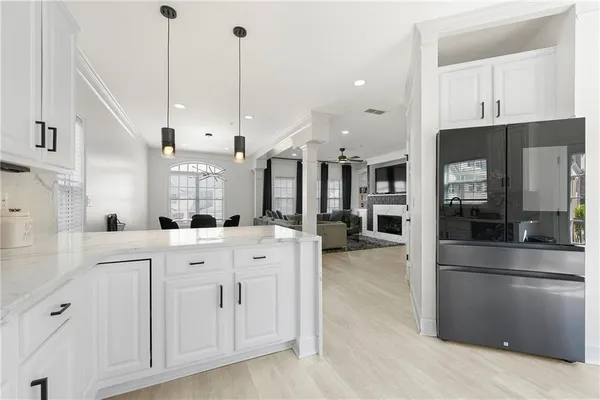 a large white kitchen with stainless steel appliances