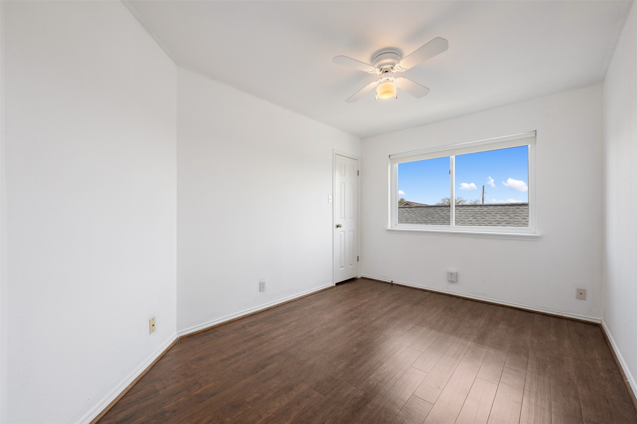 104 Sunset Road Georgetown, TX 78633 - Photo 31 of 40 a view of an empty room with wooden floor and a ceiling fan