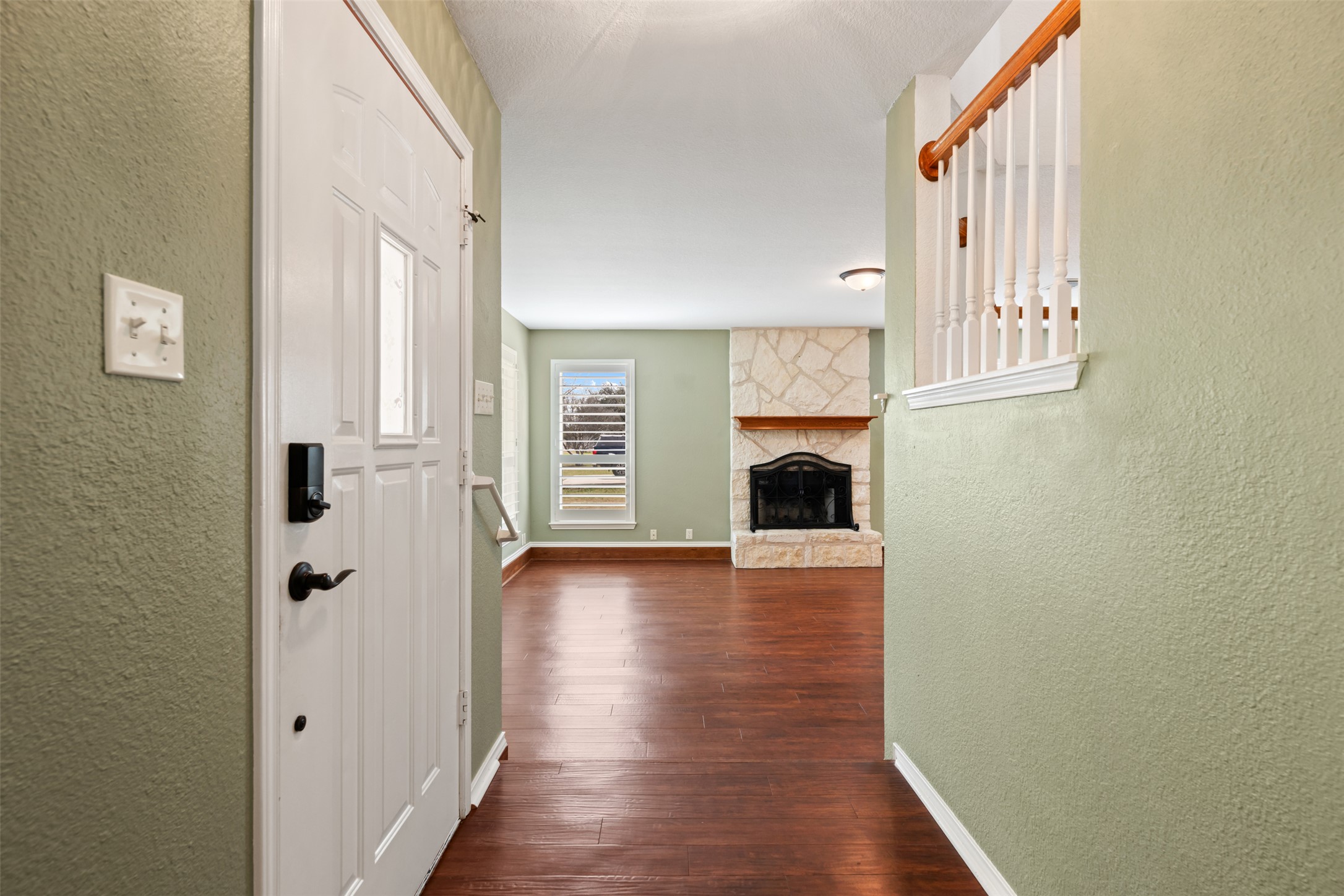 104 Sunset Road Georgetown, TX 78633 - Photo 5 of 40 a view of a hallway with wooden floor and staircase