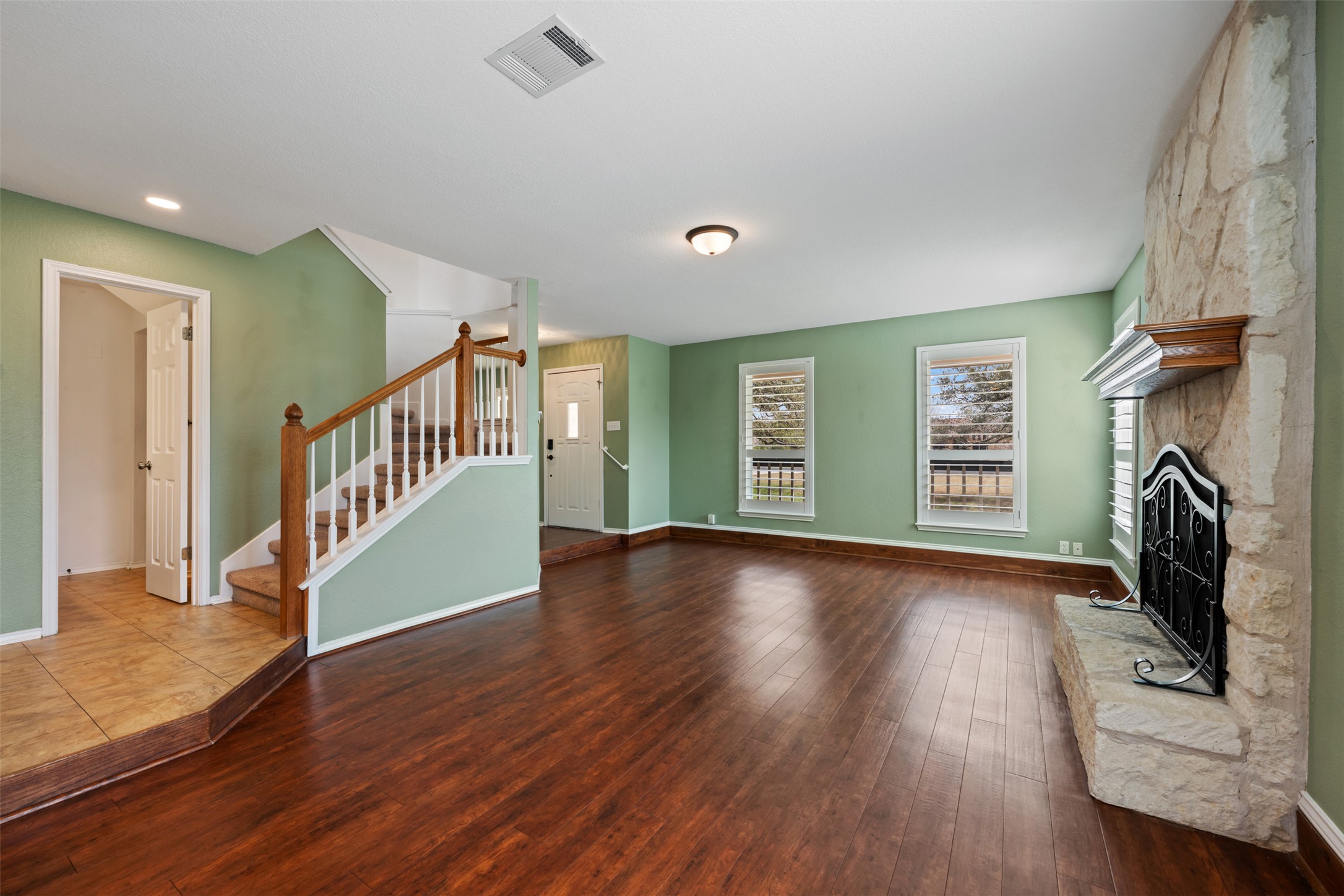 104 Sunset Road Georgetown, TX 78633 - Photo 8 of 40 a view of an empty room with wooden floor fireplace and a window