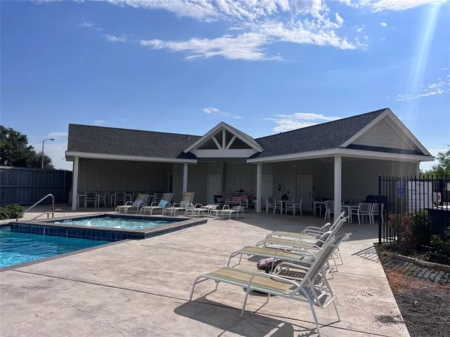 a roof deck with table and chairs under an umbrella