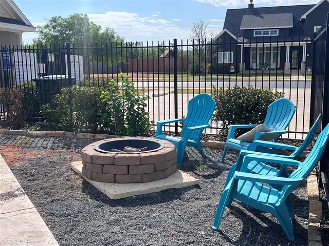 a view of a chairs and table in the backyard