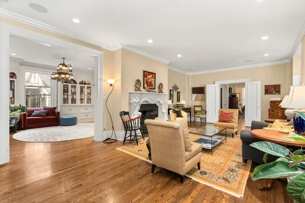 a living room with fireplace furniture and a wooden floor