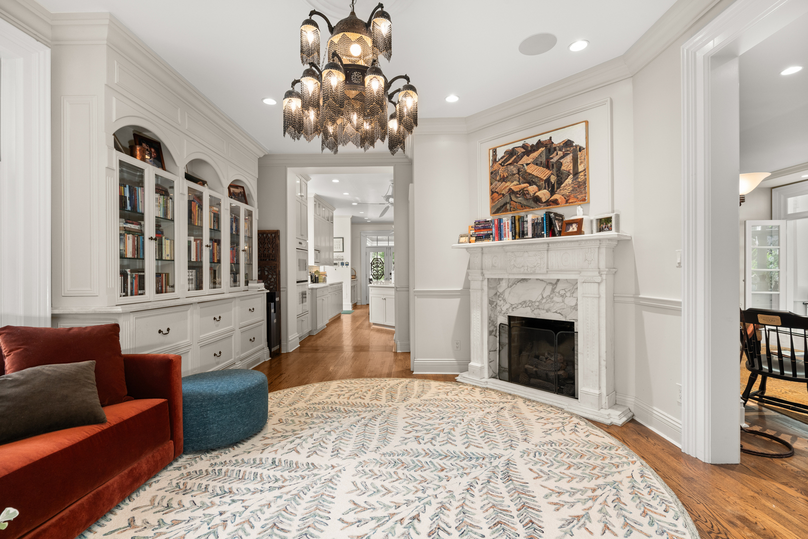 201 Scottswood Road Riverside, IL 60546 - Photo 17 of 32 a living room with furniture a chandelier and a fireplace