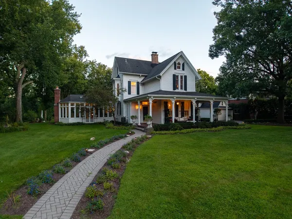 a front view of a house with yard and green space