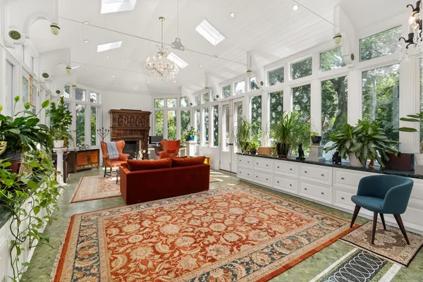 a living room with furniture fireplace and a potted plant