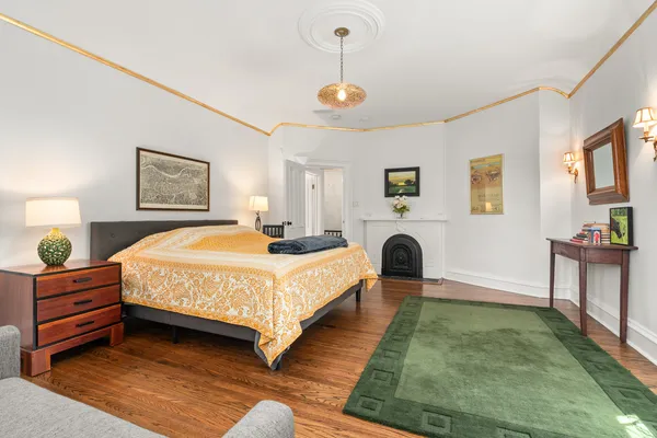 a bedroom with a bed and a chandelier