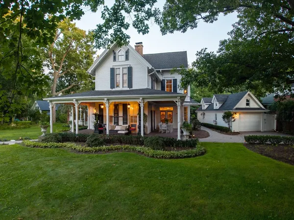 a front view of a house with a yard and outdoor seating