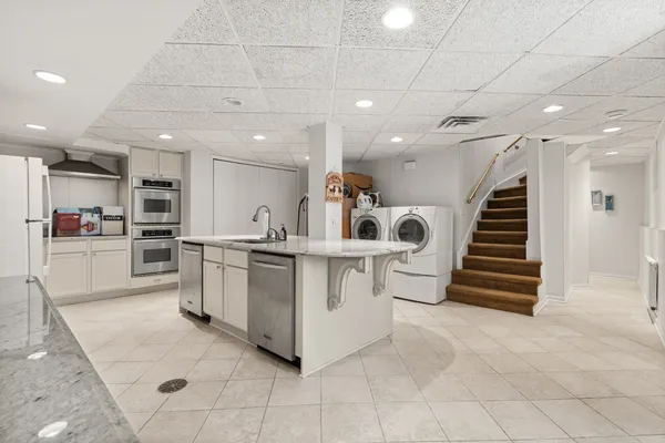 a large white kitchen with lots of white appliances