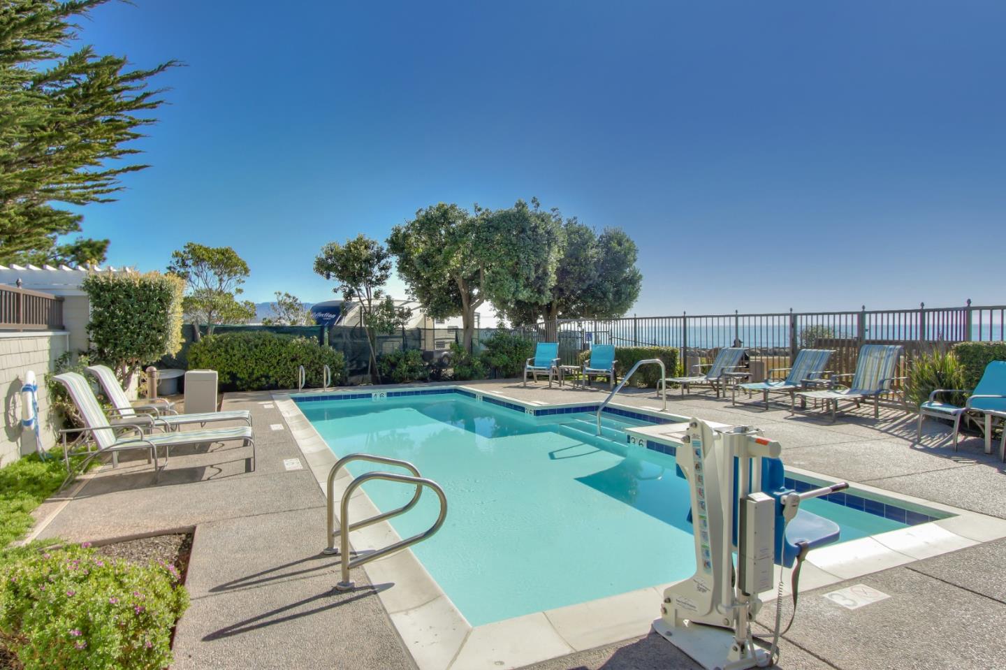 4100 Cabrillo Highway, Unit 105 Half Moon Bay, CA 94019 - Photo 13 of 19 a view of a swimming pool and lounge chairs