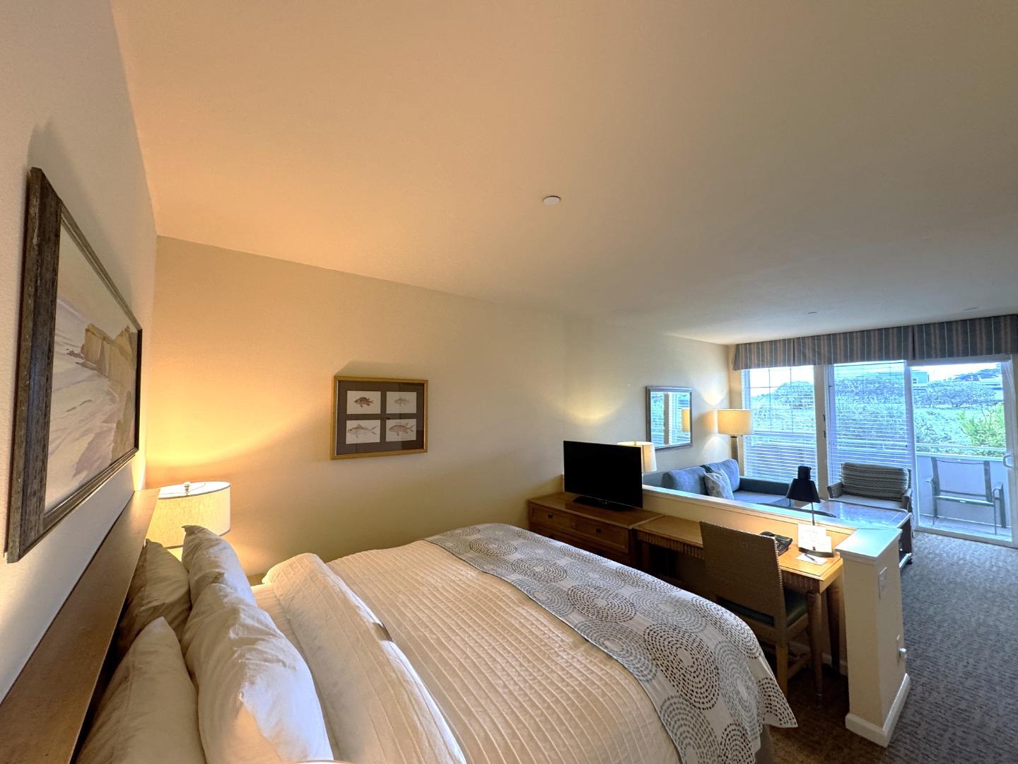 4100 Cabrillo Highway, Unit 105 Half Moon Bay, CA 94019 - Photo 3 of 19 a bedroom with a bed and a flat tv screen on dresser