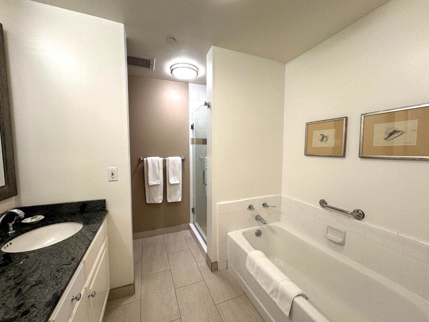 4100 Cabrillo Highway, Unit 105 Half Moon Bay, CA 94019 - Photo 7 of 19 a spacious bathroom with a tub sink and mirror