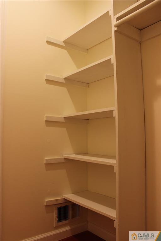 1706 Timber Oaks Road, Unit 1706 Edison, NJ 08820 - Photo 21 of 25 a view of storage and utility room with racks on the wall