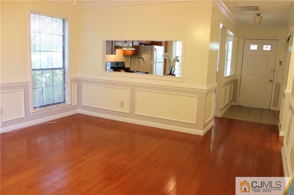 1706 Timber Oaks Road, Unit 1706 Edison, NJ 08820 - Photo 6 of 25 a view of a hallway with wooden floor and a bathroom