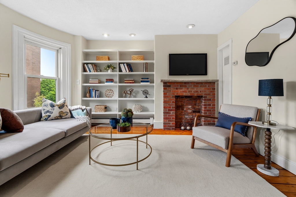 88 West Springfield Street, Unit 3 Boston, MA 02118 - Photo 2 of 17 a living room with furniture flat screen tv and a fireplace