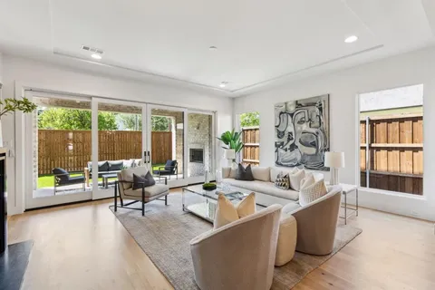 a living room with furniture and large windows