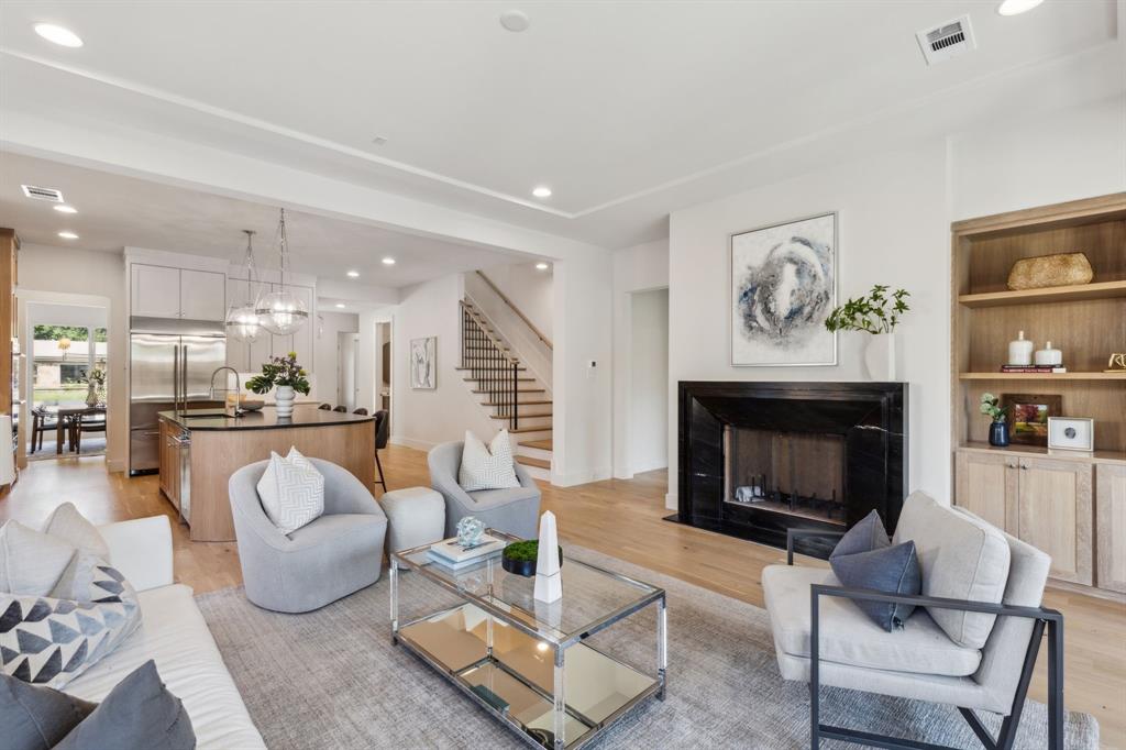 7611 Caillet Street Dallas, TX 75209 - Photo 16 of 37 a living room with furniture and a fireplace