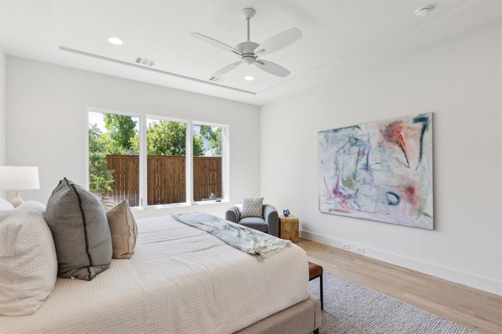 7611 Caillet Street Dallas, TX 75209 - Photo 18 of 37 a bedroom with a large bed and a painting on the wall