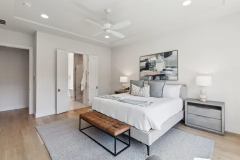 a bedroom with a bed and a night stand