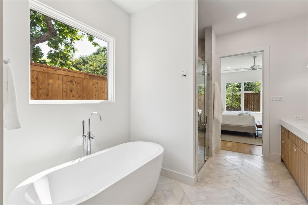 7611 Caillet Street Dallas, TX 75209 - Photo 22 of 37 a en suite bathroom with a tub and window