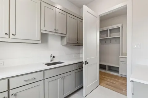 a kitchen with white cabinets and a sink