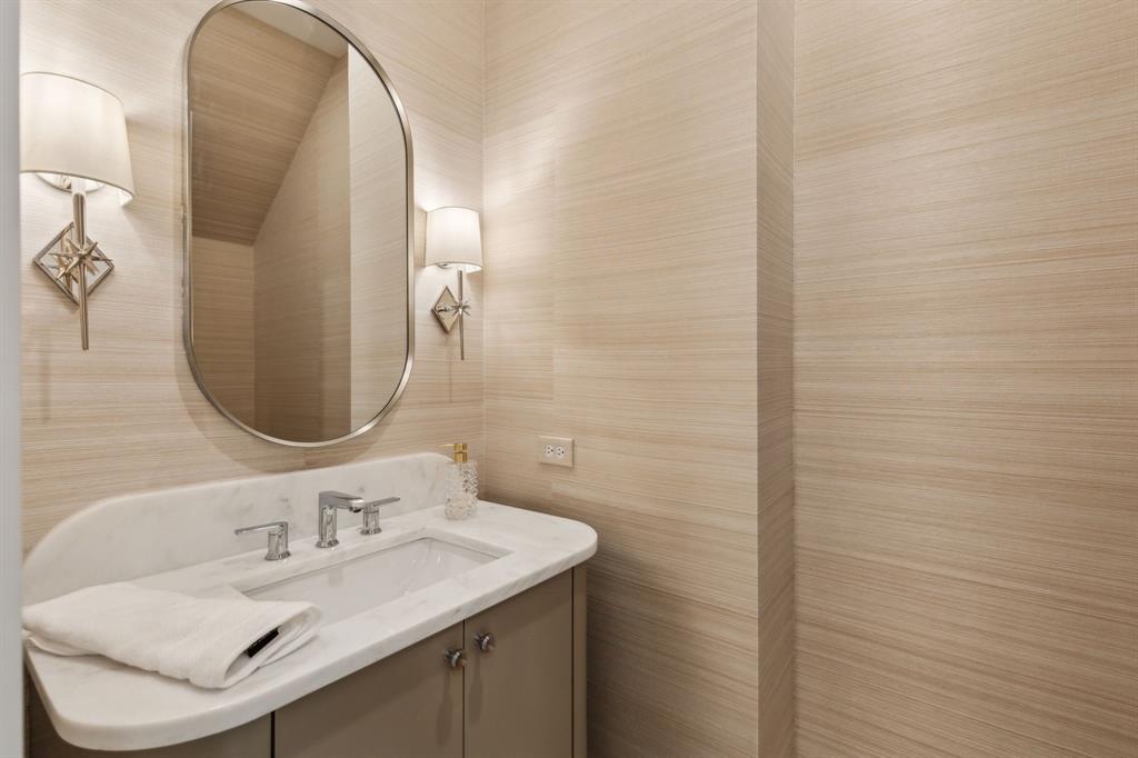 7611 Caillet Street Dallas, TX 75209 - Photo 24 of 37 a bathroom with a sink and a mirror
