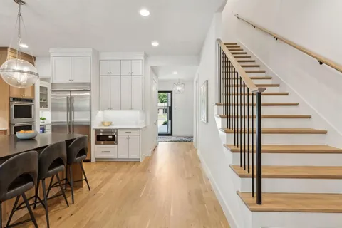 a view of a kitchen with cabinets and wooden floor