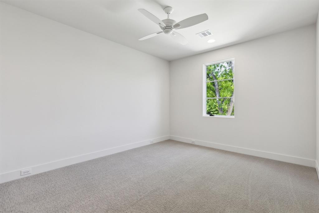 7611 Caillet Street Dallas, TX 75209 - Photo 33 of 37 an empty room with a window and a ceiling fan