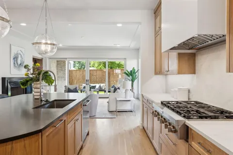 a kitchen with sink stove and cabinets