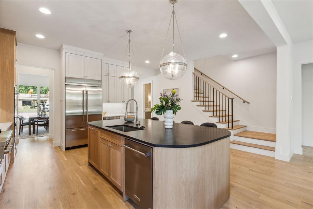 7611 Caillet Street Dallas, TX 75209 - Photo 8 of 37 a kitchen with stainless steel appliances granite countertop a sink a refrigerator and a stove