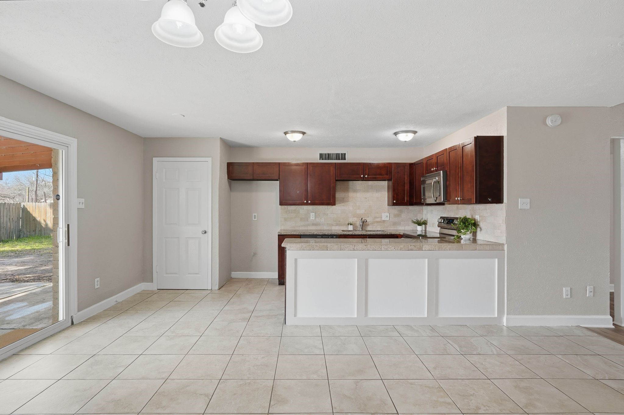 17223 Ranch Country Road Hockley, TX 77447 - Photo 11 of 36 Check out your kitchen with beautiful rich cabinets and a large island overlooking your dining room.
