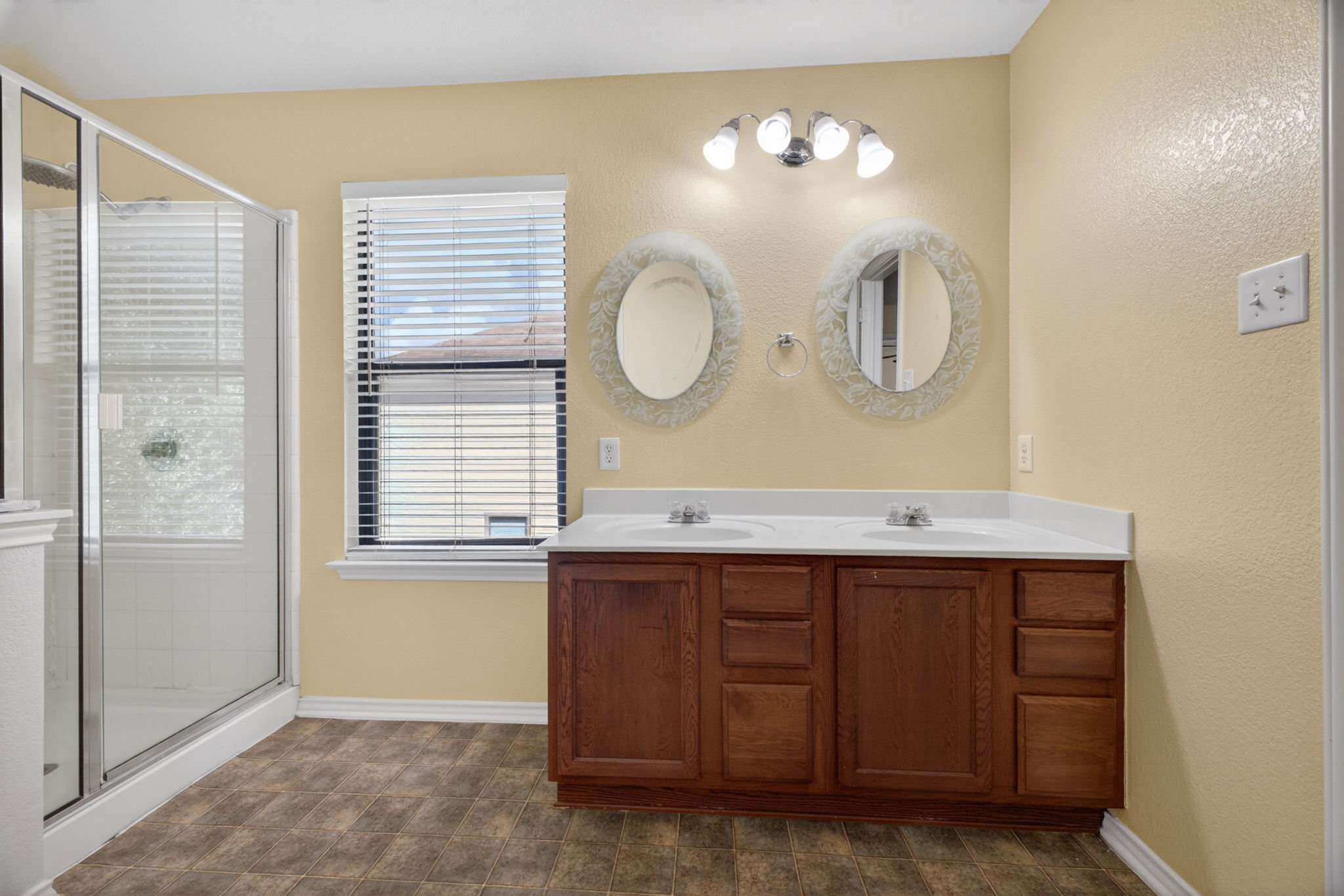 8813 Wiley Way Austin, TX 78747 - Photo 22 of 39 Primary bathroom with dual vanity and a window that allows natural light