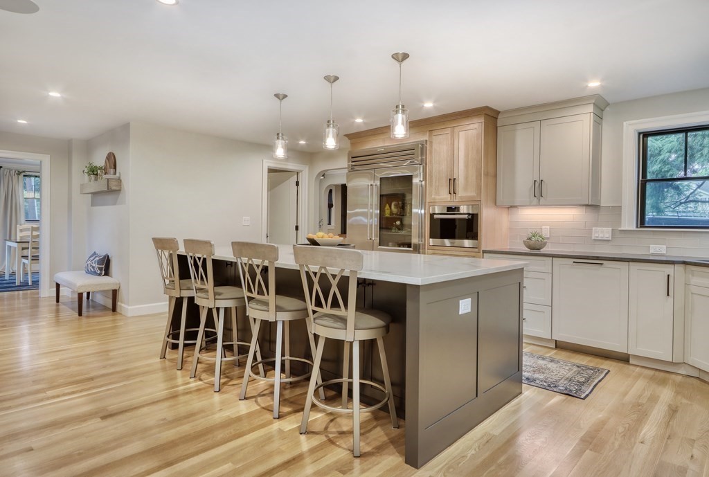 27 Cabot Street Winchester, MA 01890 - Photo 1 of 1 a kitchen with stainless steel appliances kitchen island granite countertop a table chairs sink and cabinets