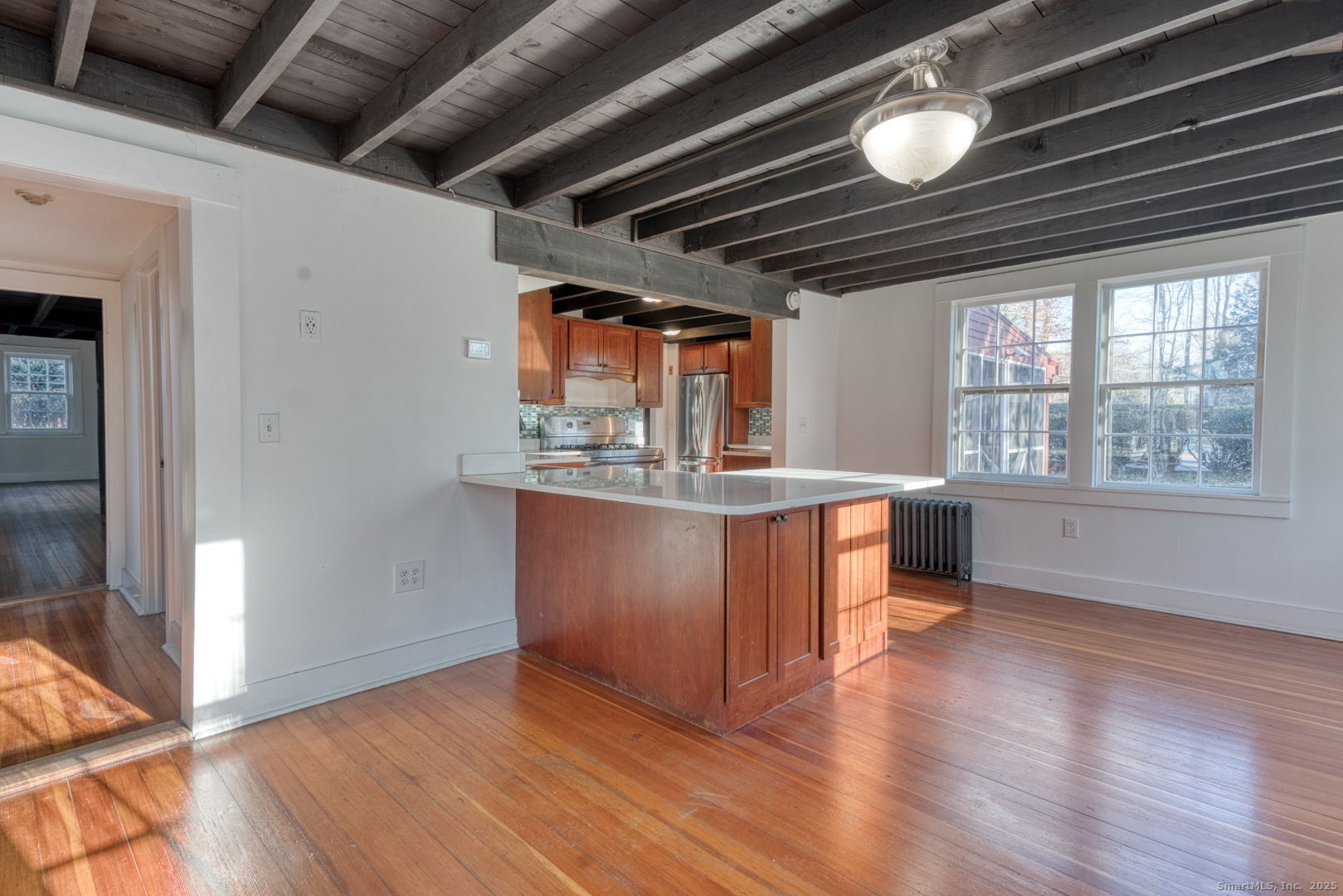 668 Middle Turnpike Mansfield, CT 06268 - Photo 11 of 40 a kitchen with stainless steel appliances granite countertop a stove a refrigerator and a wooden floors