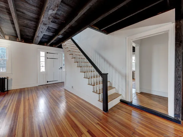 a view of entryway with wooden floor and stairs