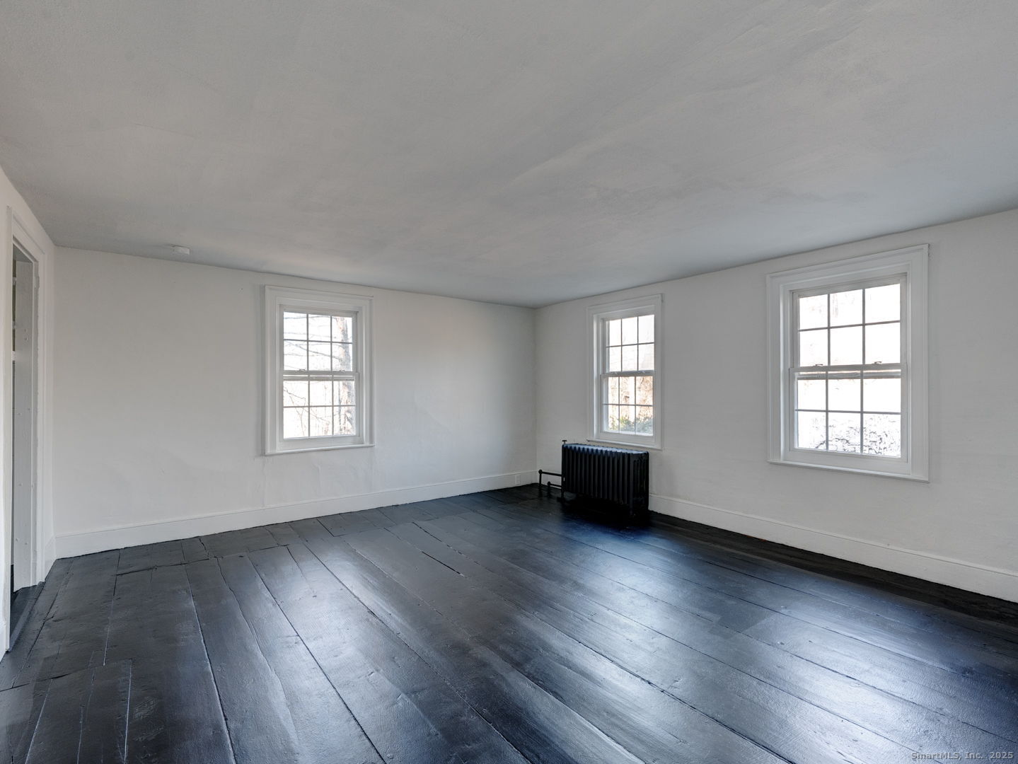 668 Middle Turnpike Mansfield, CT 06268 - Photo 19 of 40 a view of an empty room with wooden floor and a window
