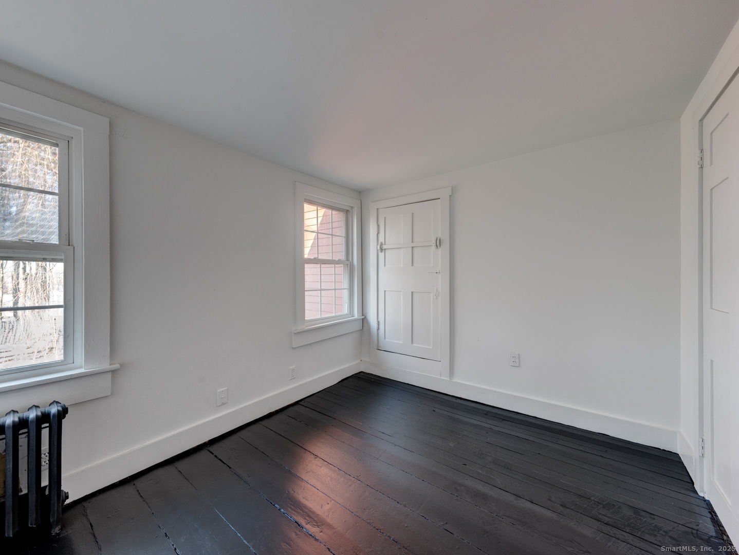 668 Middle Turnpike Mansfield, CT 06268 - Photo 22 of 40 an empty room with wooden floor and windows