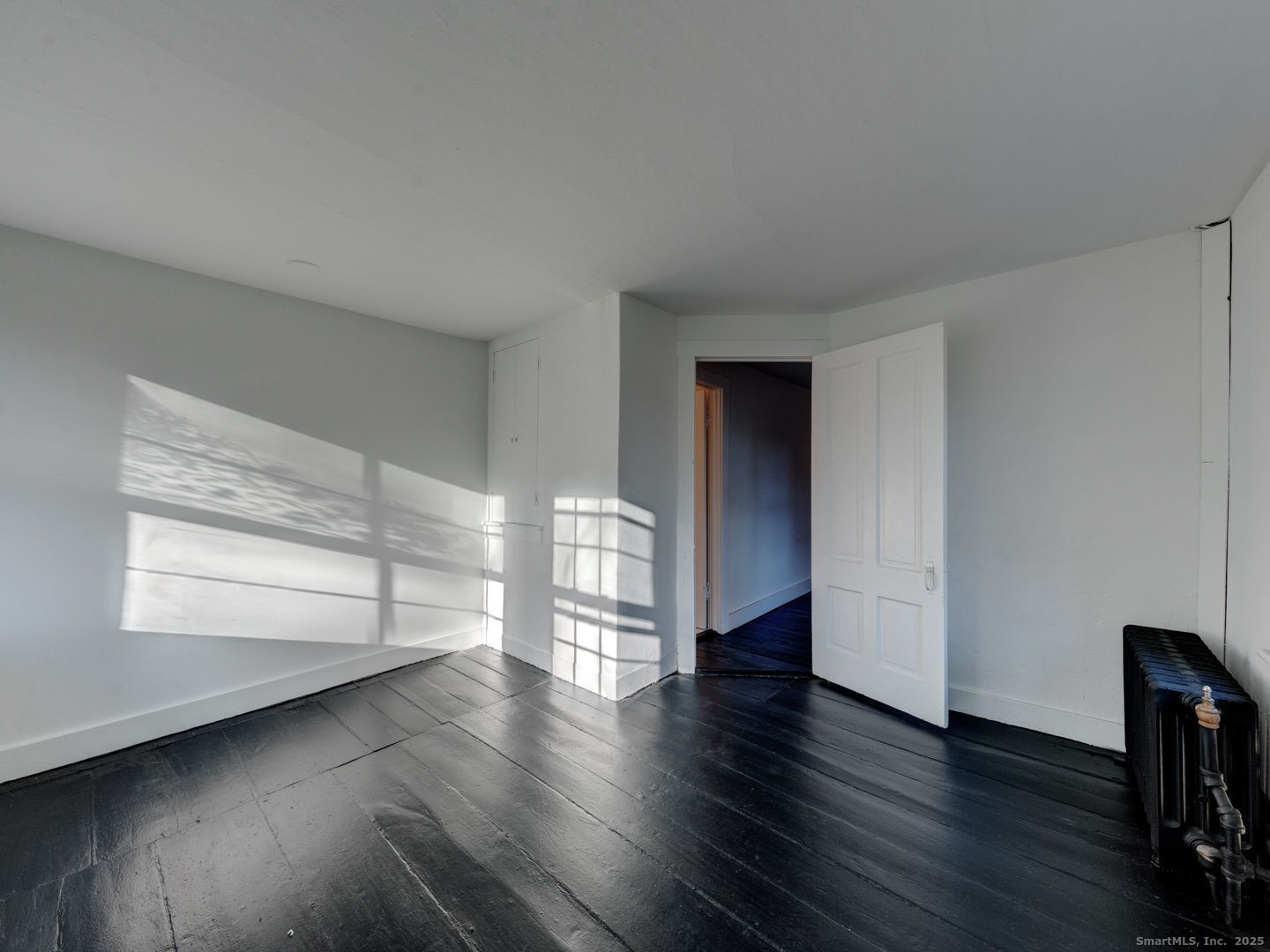 668 Middle Turnpike Mansfield, CT 06268 - Photo 23 of 40 a view of empty room with wooden floor and fan