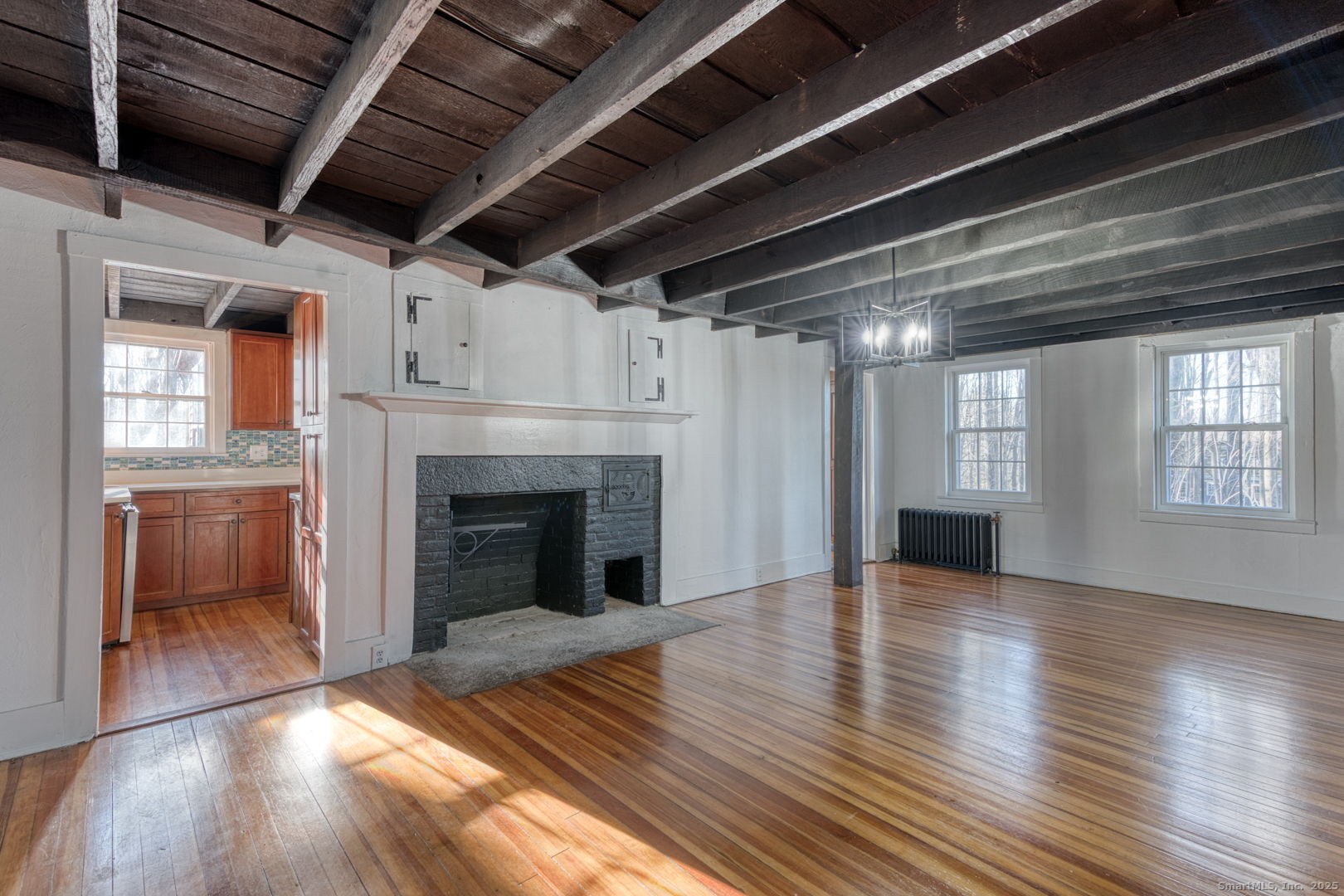 668 Middle Turnpike Mansfield, CT 06268 - Photo 28 of 40 a view of an empty room with wooden floor fireplace and a window