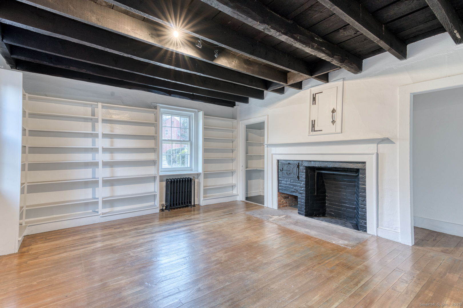 668 Middle Turnpike Mansfield, CT 06268 - Photo 31 of 40 a view of an empty room with a fireplace and a window
