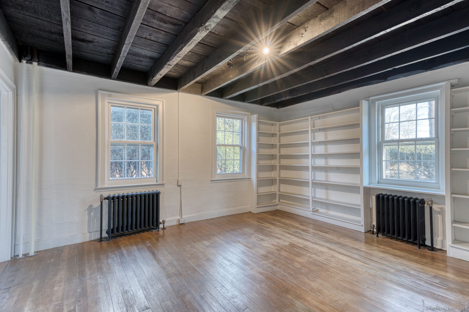 668 Middle Turnpike Mansfield, CT 06268 - Photo 32 of 40 a view of empty room with wooden floor and fan