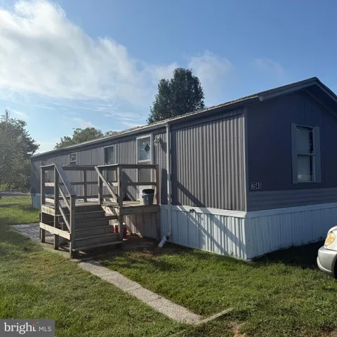 a view of a backyard with wooden fence