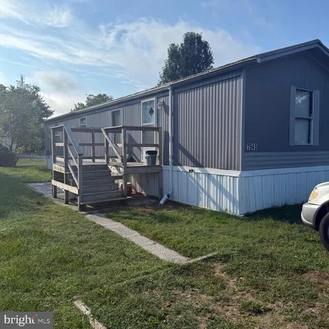 a view of a backyard with wooden fence